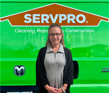person in front of servpro sign