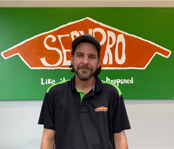 man in front of Servpro sign